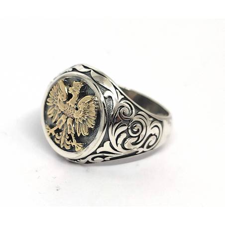 Srebrny sygnet ze zlotym orłem w koronie